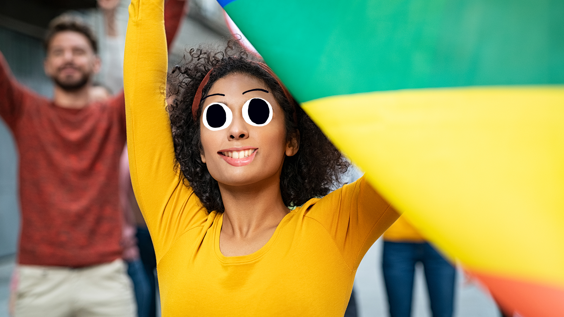 A woman holds a rainbow flag