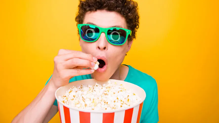 A person snacking on popcorn