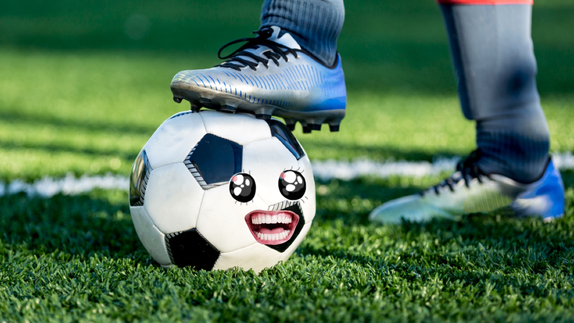 A footballer with their foot resting on a ball