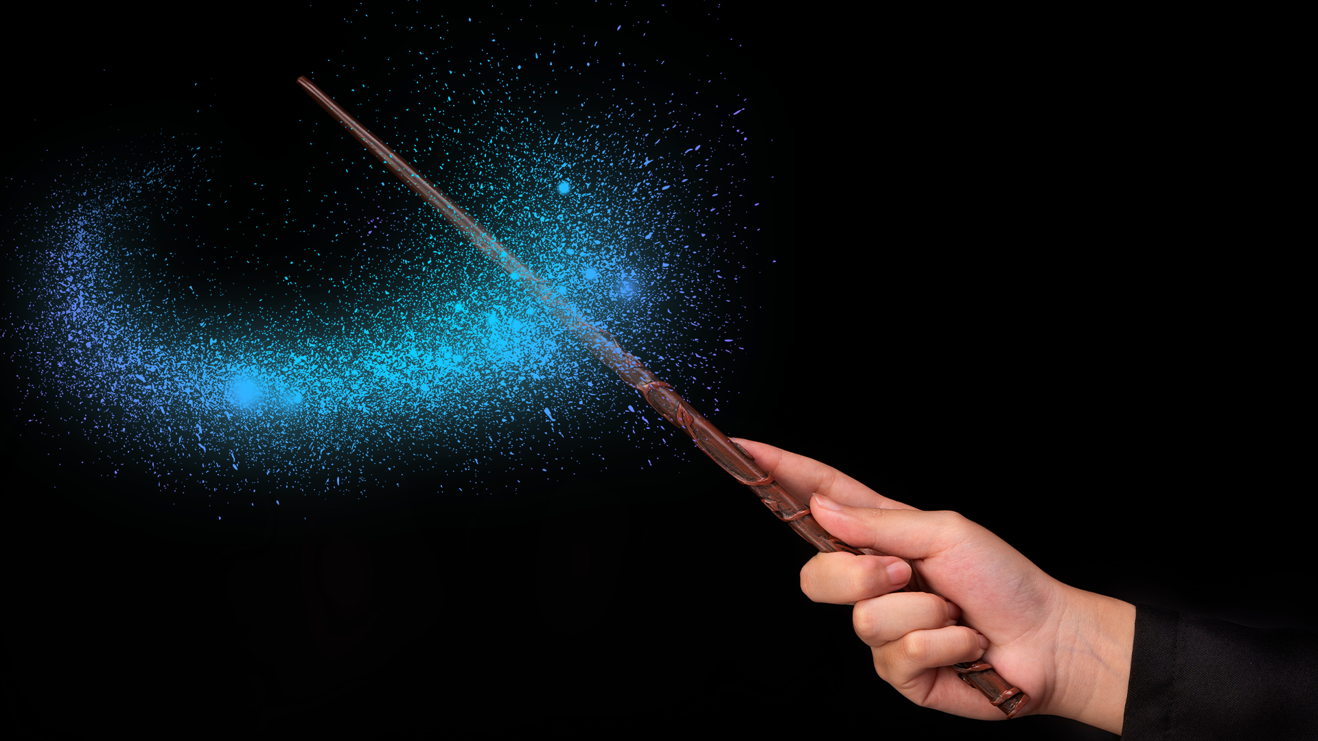 Hand waving magic wand with magic dust