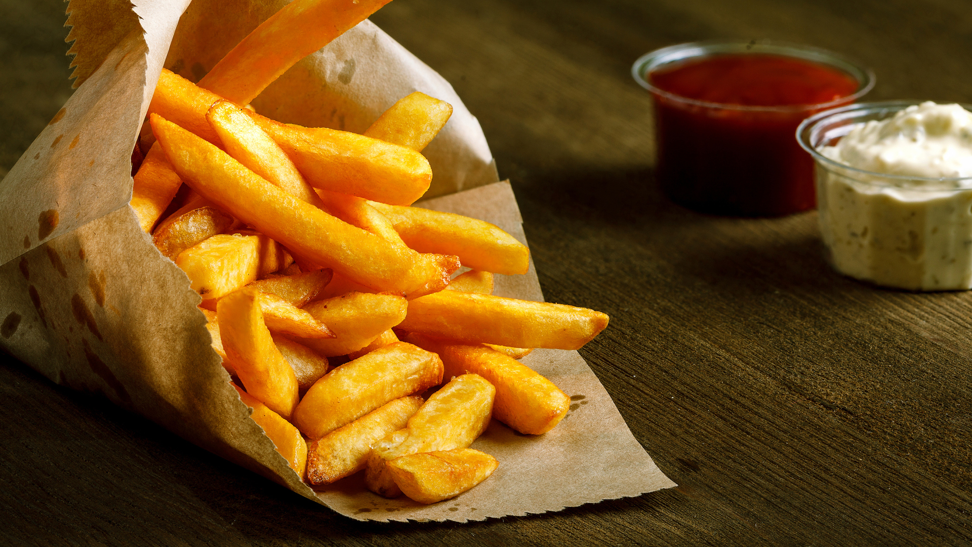 A bag of chips with ketchup and mayonnaise 