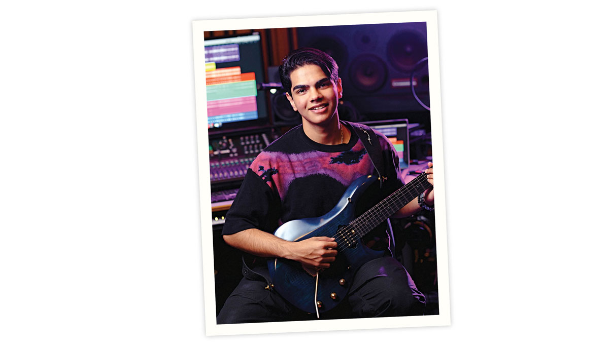 Tamish Pulappadi playing guitar in a recording studio.