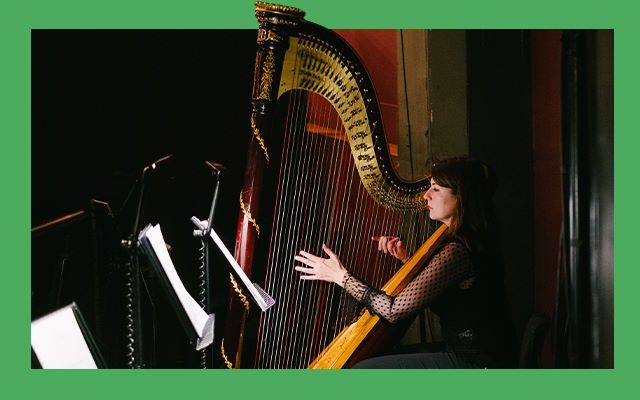 A woman playing the harp.