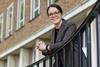 Ruth Webster standing next to railing in front of a university building