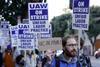 People on a protest. Their placards read UAW on strike.