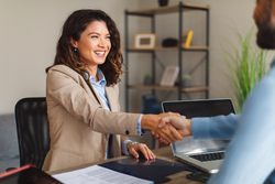 Young woman signing contracts and handshake with a manager