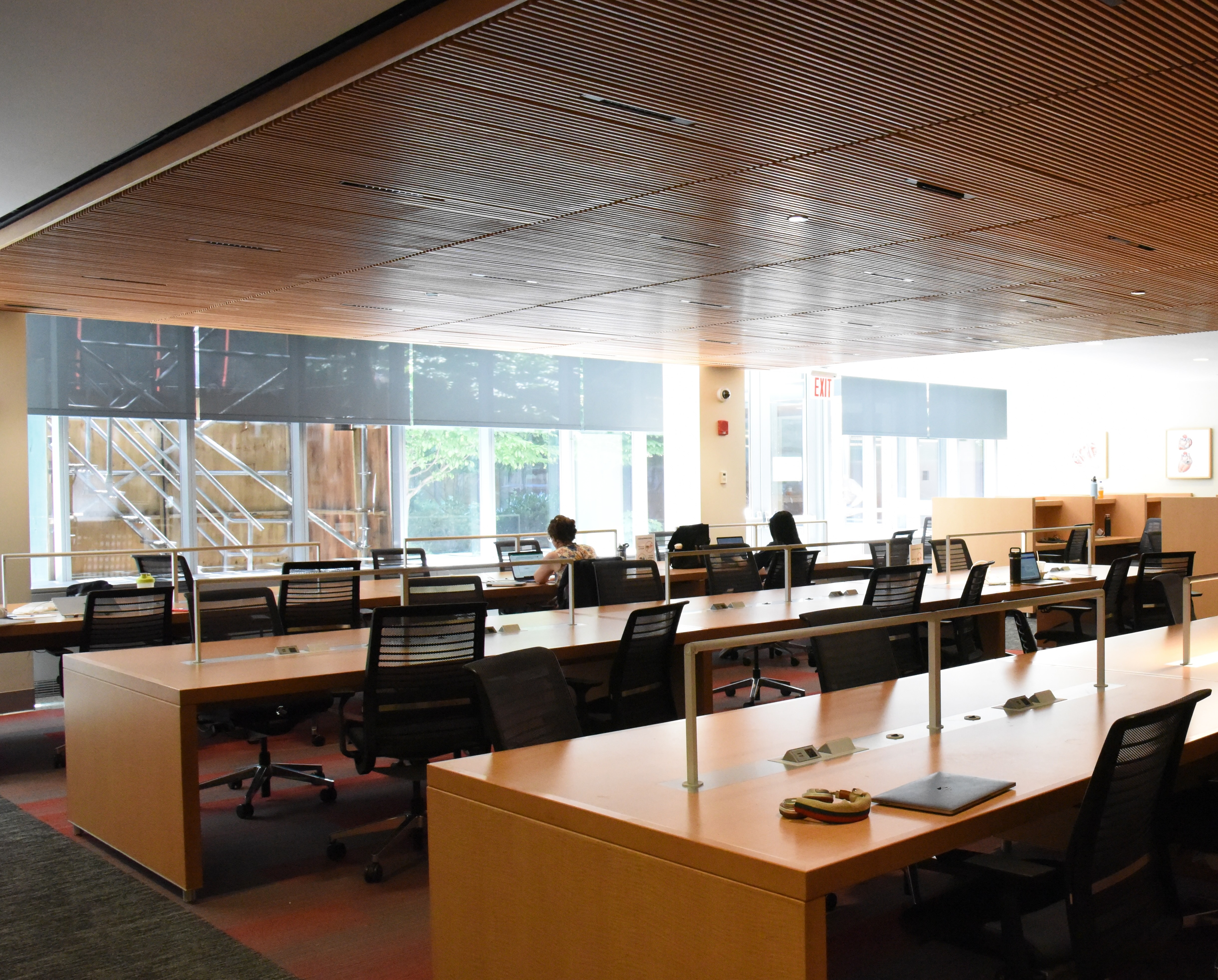 quiet study space long wooden desks and faces windows