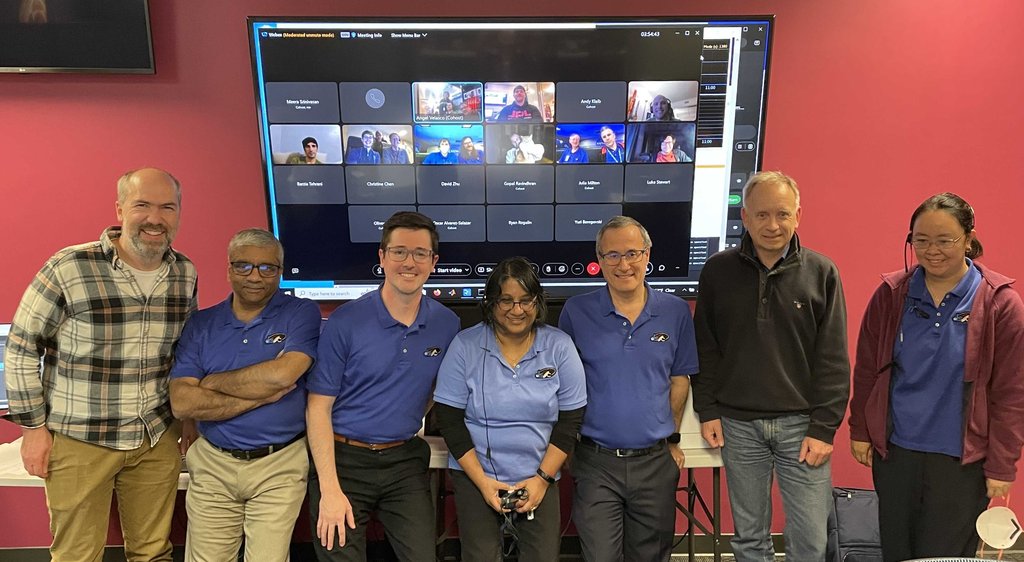 Members of the JPL team pose after the first streamed ultra-HD video was received from deep space.