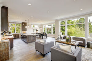 Open plan kitchen equipped with high-end appliances opens to the dining room and the great room with lots of natural light provided by white framed windows. Northwest, USA