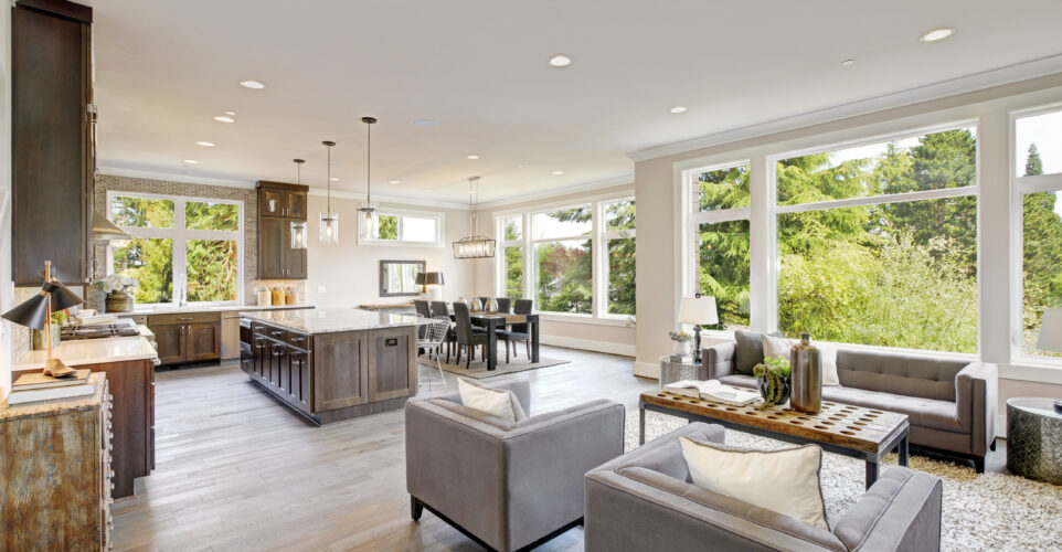 Open plan kitchen equipped with high-end appliances opens to the dining room and the great room with lots of natural light provided by white framed windows. Northwest, USA