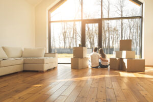 young couple moves to a new home. the family carries boxes of things after buying a home