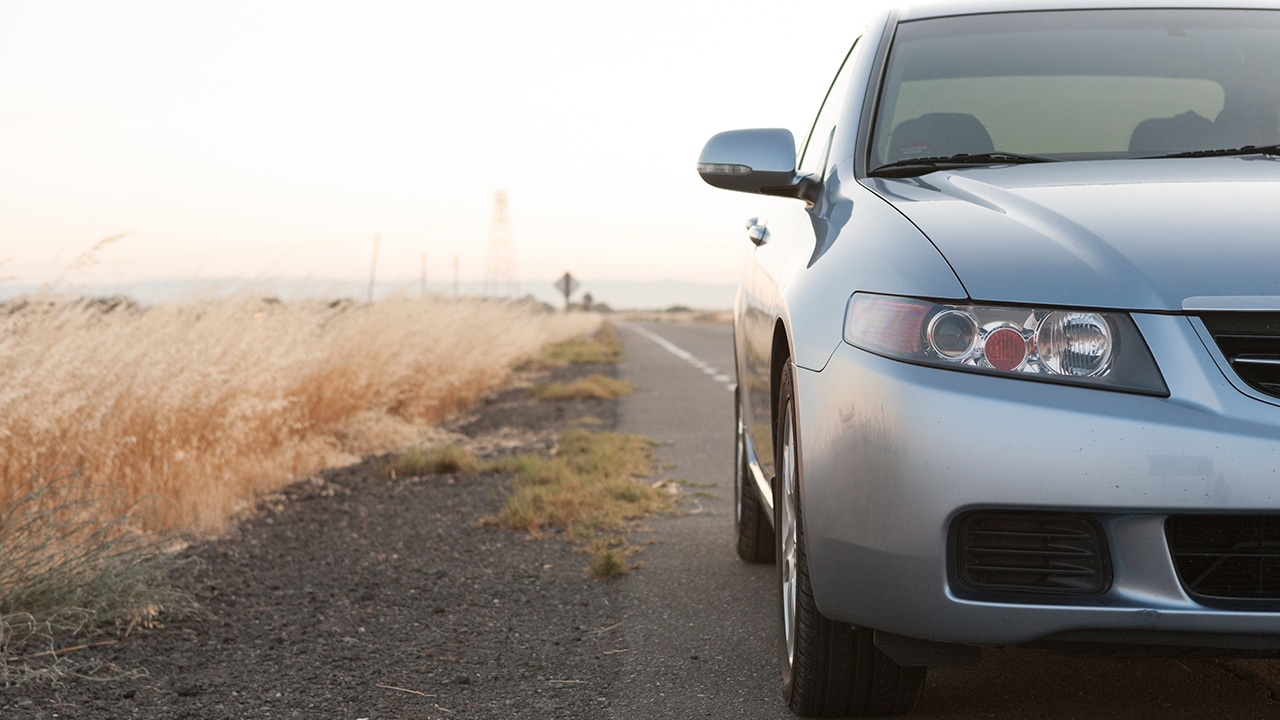 Acura TSX on side of the road in a countryside.