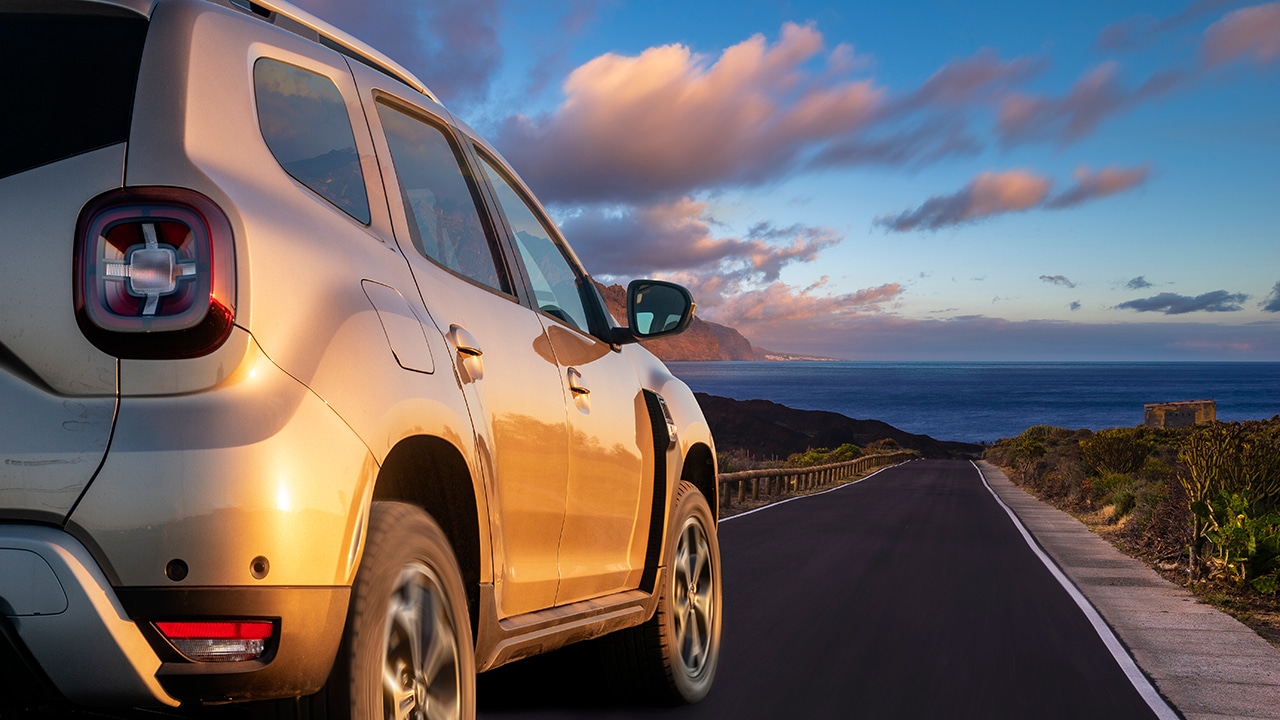 modern SUV speeding at high speed on the way leading to the ocean