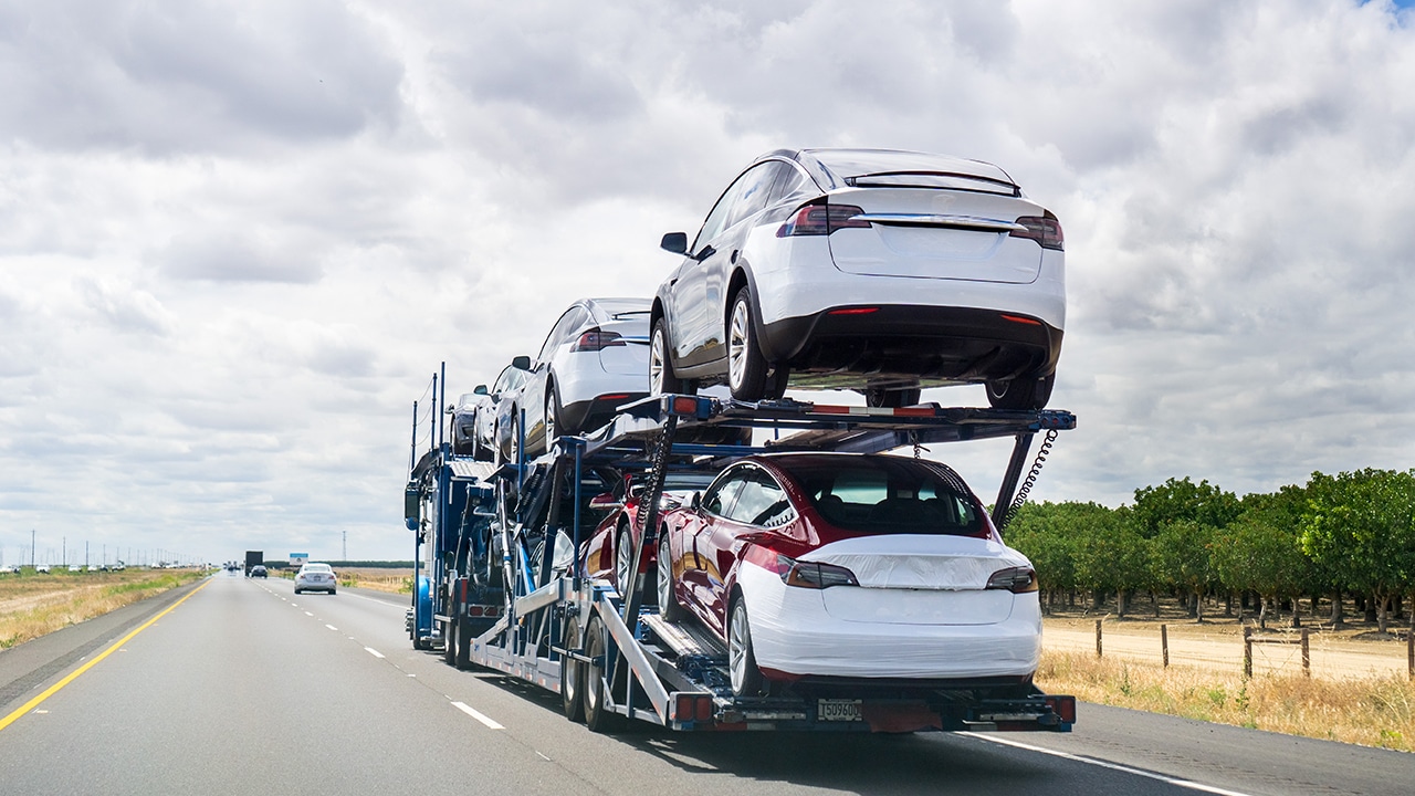 Car transporter carries new vehicles