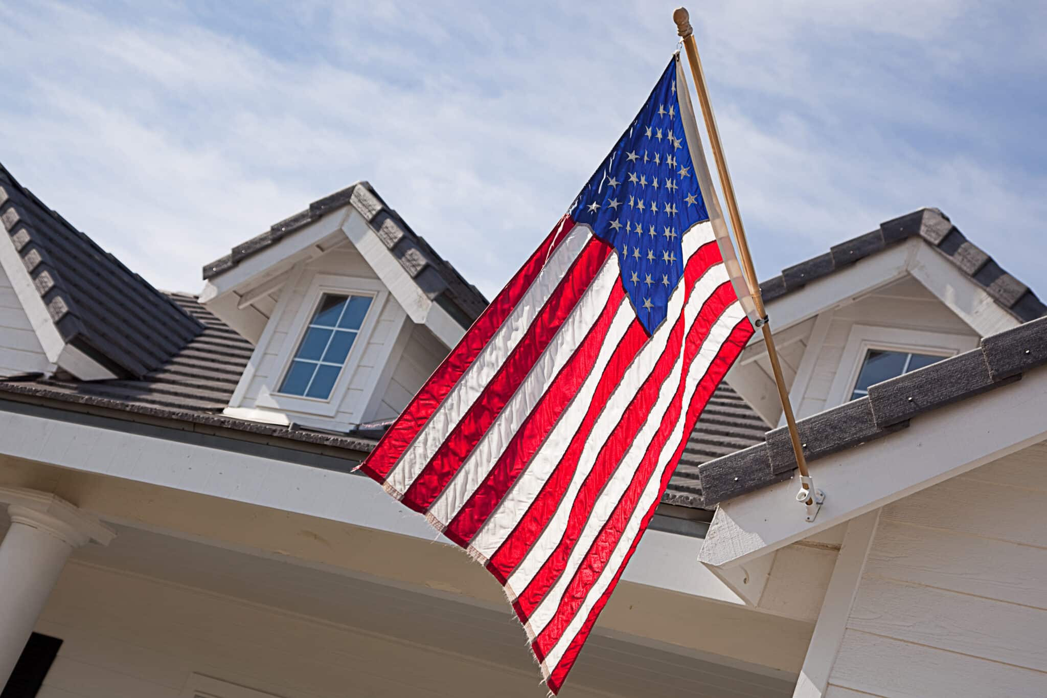 Abstract House Facade & American Flag Against a Blue Sky