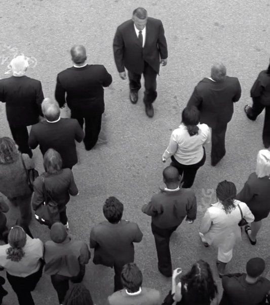 Man walking against crowd