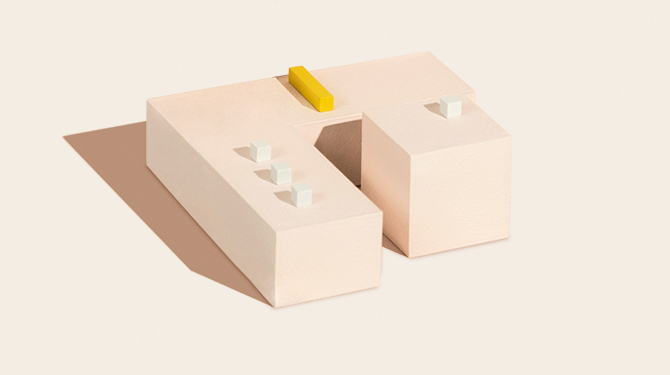 Large tan box with white cubes and a yellow rectangle block on top