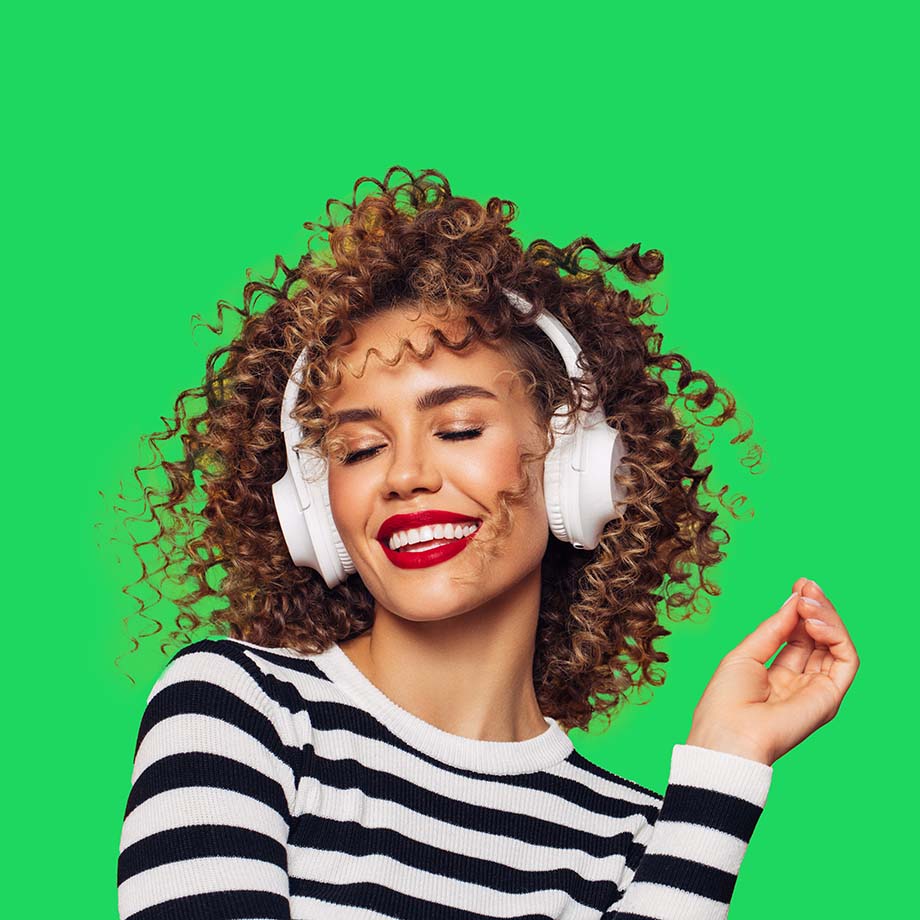 Woman wearing headphones smiling