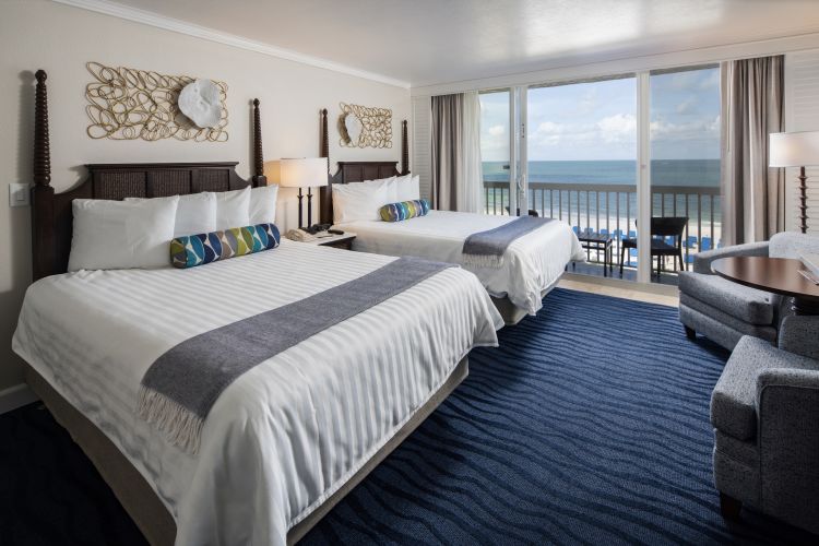 A Bedroom With A Large Bed In A Hotel Room