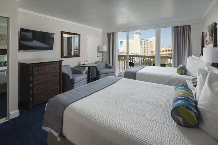 A Bedroom With A Large Bed In A Hotel Room