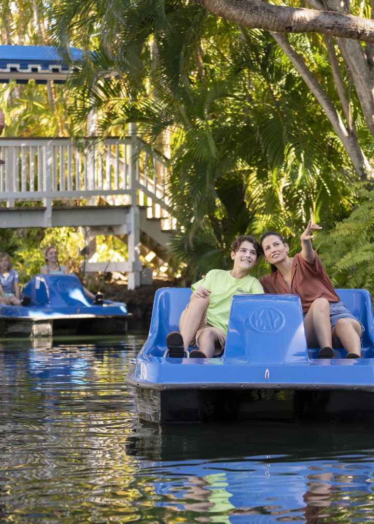 A Person Riding On The Back Of A Boat In The Water