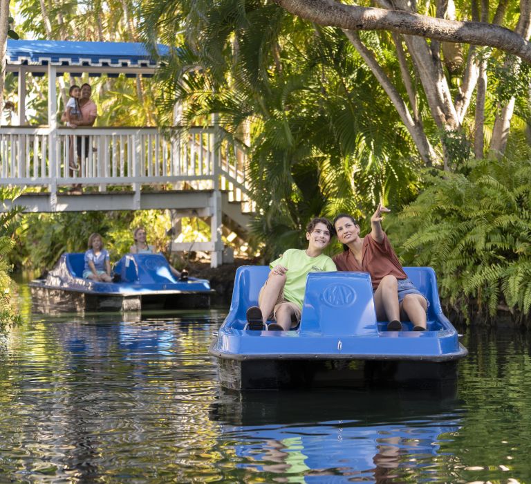 A Person Riding On The Back Of A Boat In The Water