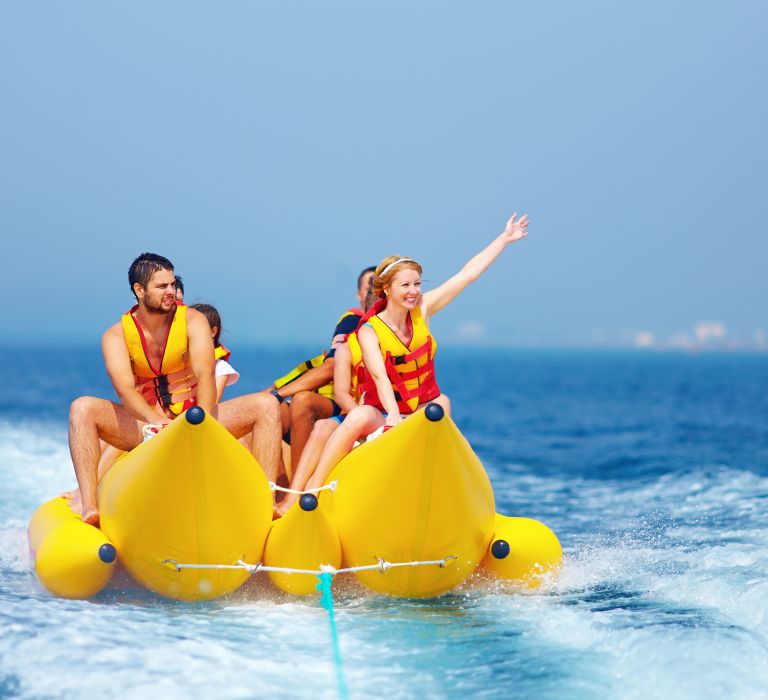 People on a banana boat ride on the water