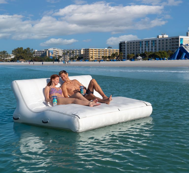 A Man And Woman On A Small Boat In The Water