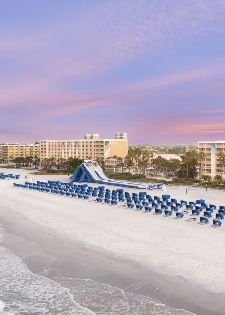 A Beach With Chairs And Umbrellas