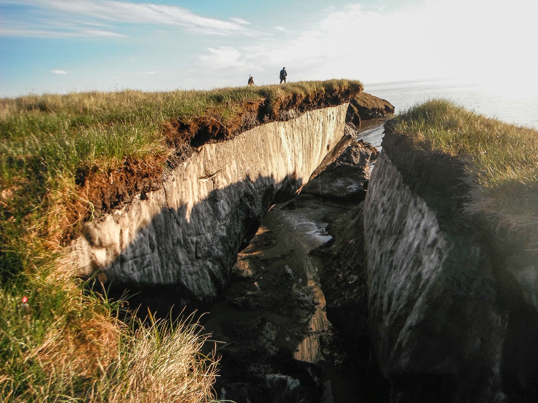 Rift in the ground showing the extent of permafrost under the biologically active topsoil.