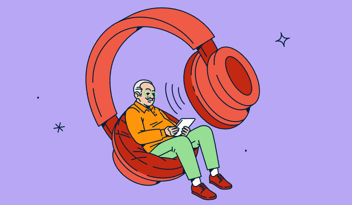 A person looking at a tablet while sitting in one side of a giant pair of headphones.