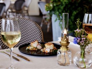 A Plate Of Sushi And Wine Glasses On A Table