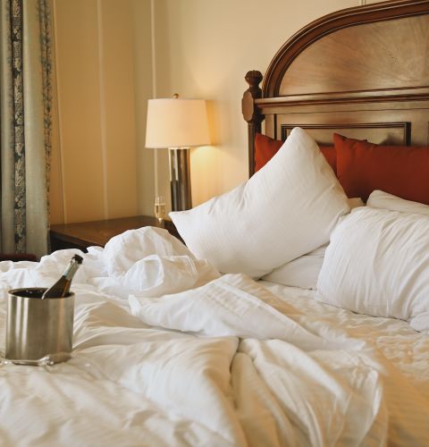 A Hotel Room With A Bed And A Coffee Table