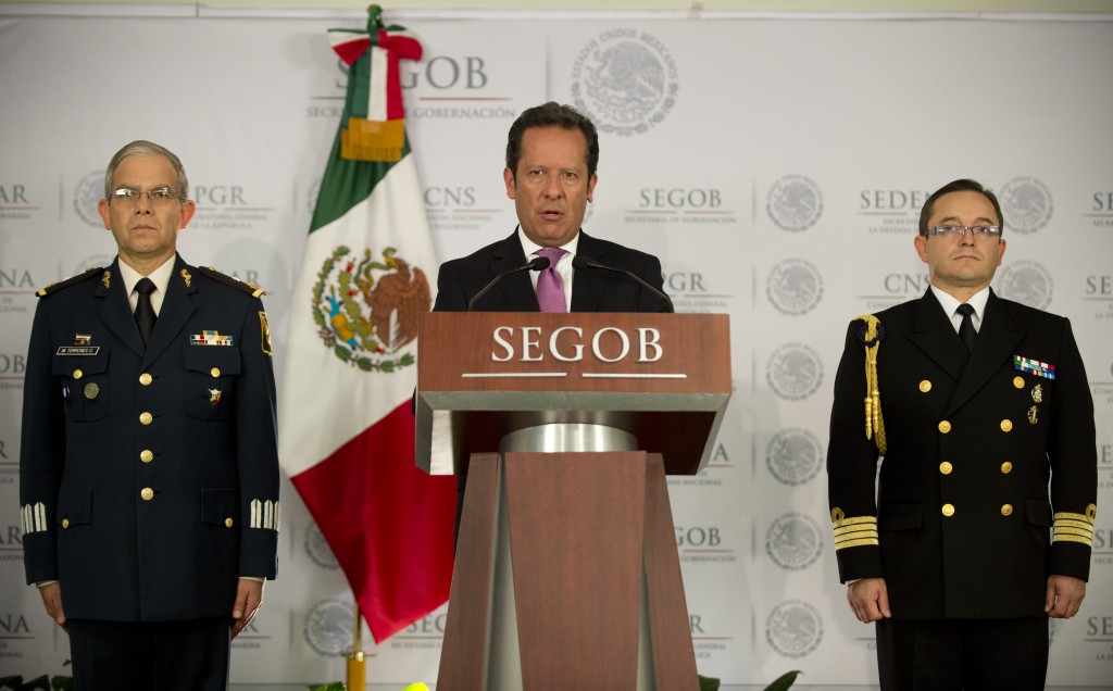 Mexican government security spokesman Eduardo Sanchez (C) speaks during a press conference, accompanied by Mexican Navy General Jorge Victor (L) and Mexican Army General Martin Terrones (R) to present details of the military operation in which Miguel Angel Trevino Morales, the alleged drug lord behind the cartel Los Zetas, was arrested. Photo by Yuri Cortez/AFP/Getty Images