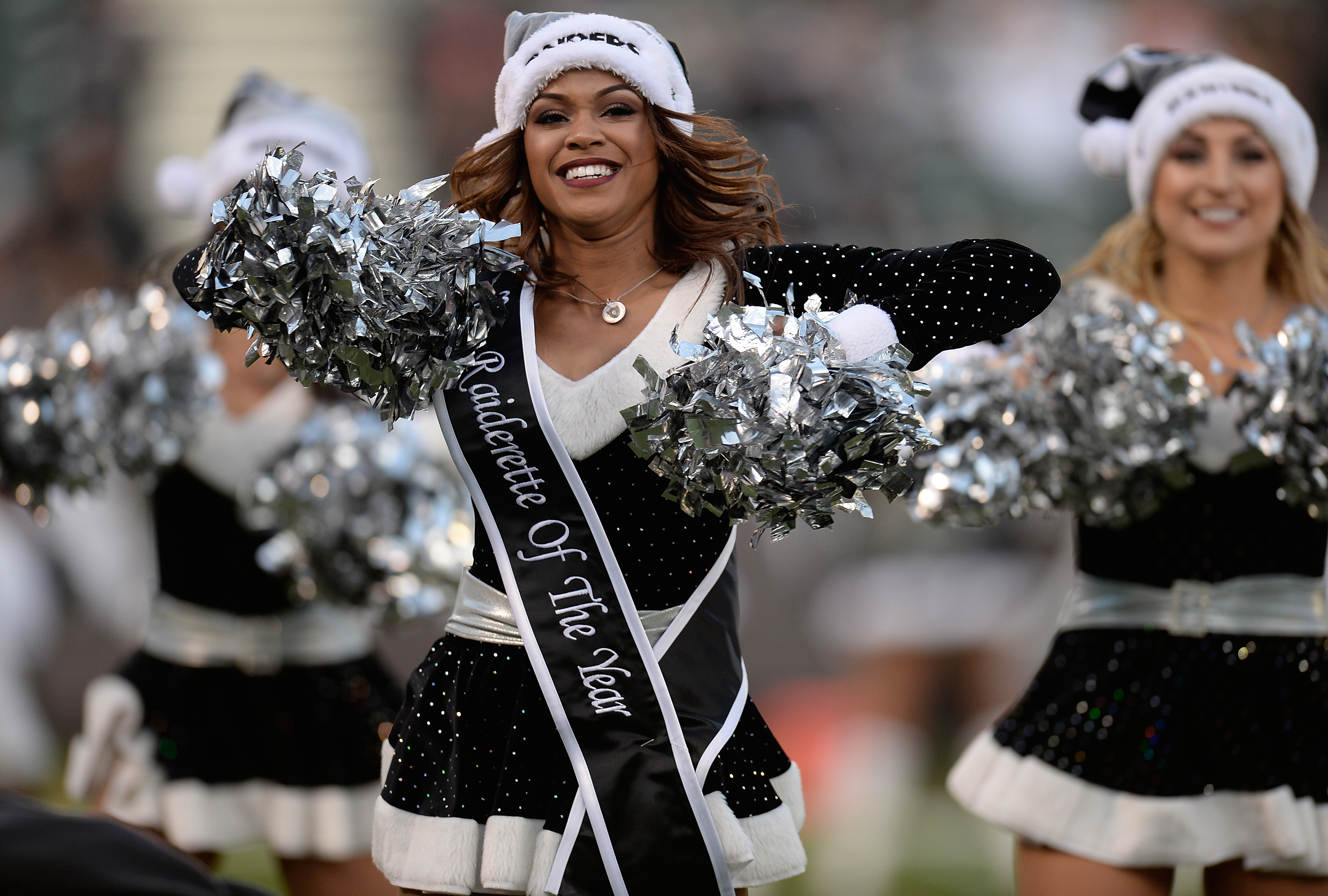 OAKLAND, CA - DECEMBER 15: The Raiderettes the Oakland Raiders Cheerleaders performs during an NFL Football game against the Kansas City Chiefs at O.co Coliseum on December 15, 2013 in Oakland, California. (Photo by Thearon W. Henderson/Getty Images)