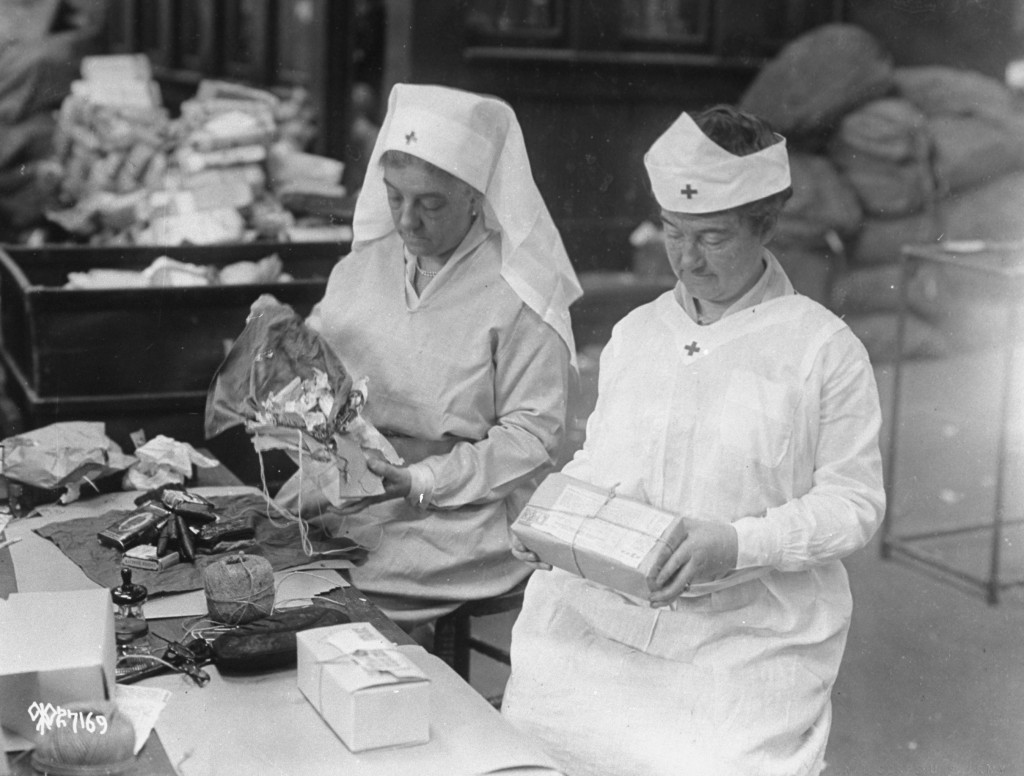 In this 1918 photo, American Red Cross women wrap food packages to be sent overseas during WWI. Photo by Time & Life Pictures/Getty Images