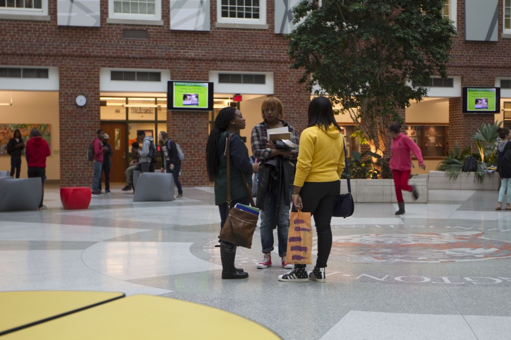 Students socialize in Wilson High School's atrium in Washington, D.C., April 30, 2014. The school's principal, Peter Cahall, said the atrium has become a place where student of all races hang out.
