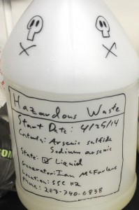 Hand-drawn skull-and-crossbones mark a hazardous waste container used by scientists at a lab at the University of Southern California. Scientists at USC are doing basic research to determine how certain bacteria are able to transfer electrons great distances from themselves to other cells or inorganic minerals. Photograph by Kent Treptow for PBSNewsHour