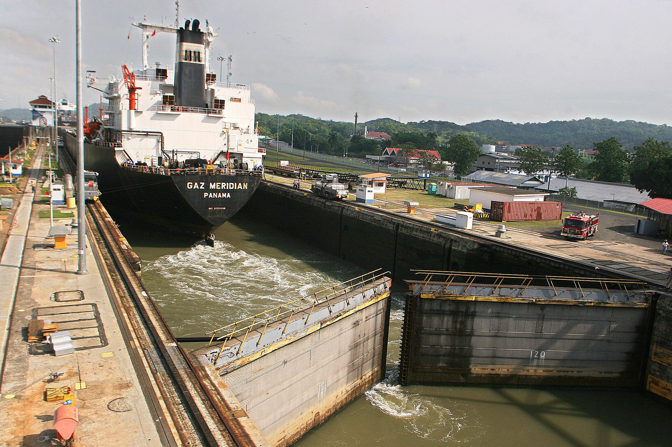 A tanker crosses through the Panama Canal's Miraflores locks on April 21, 2006. The locks are 110 feet wide, limiting the size of ships that can pass through. The allowable size is known as “Panamax.” The tolls for container ships to cross are about $50,000 to $250,000, cruise ships $80,000 to $300,000, and yachts and other small vessels $1,300 to $2,500. Photo by Teresita Chavarria/AFP/Getty Images