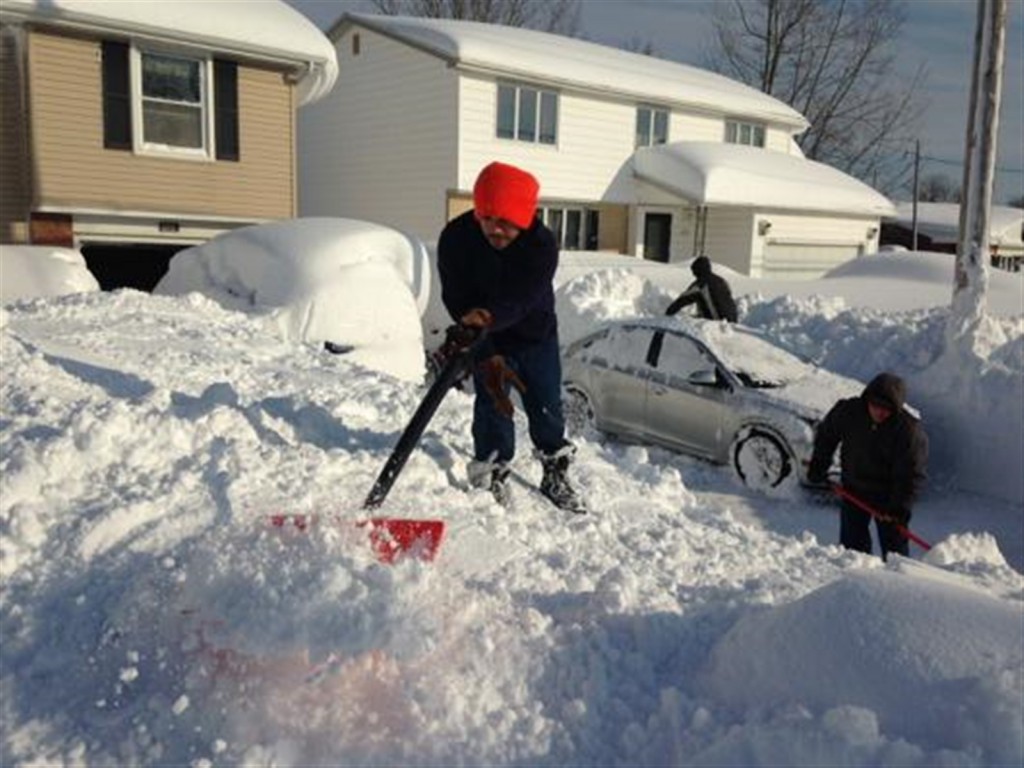 The Porto family digs out their driveway in Depew, NY. Photo courtesy: John Hickey/Buffalo News