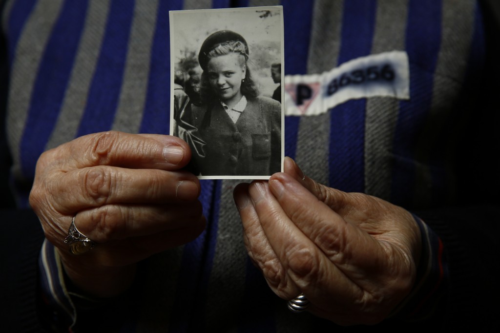 Auschwitz concentration camp survivor Jadwiga Bogucka holds a picture of herself from 1944 in Warsaw