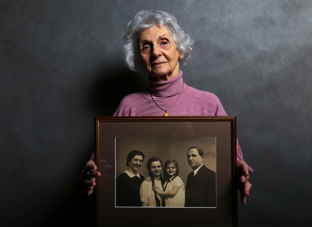 Auschwitz concentration camp survivor Eva Fahidi holds a picture of her family members, all of whom were killed in the concentration camp during World War II