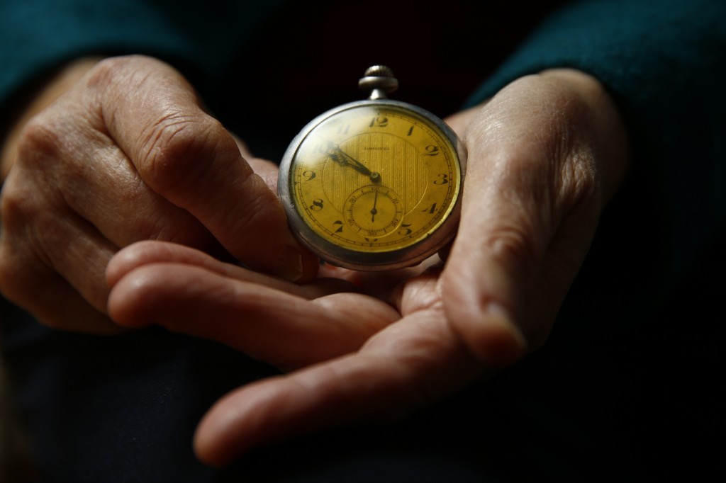 Auschwitz death camp survivor Elzbieta Sobczynska holds her father's watch as she poses for a portrait in Warsaw