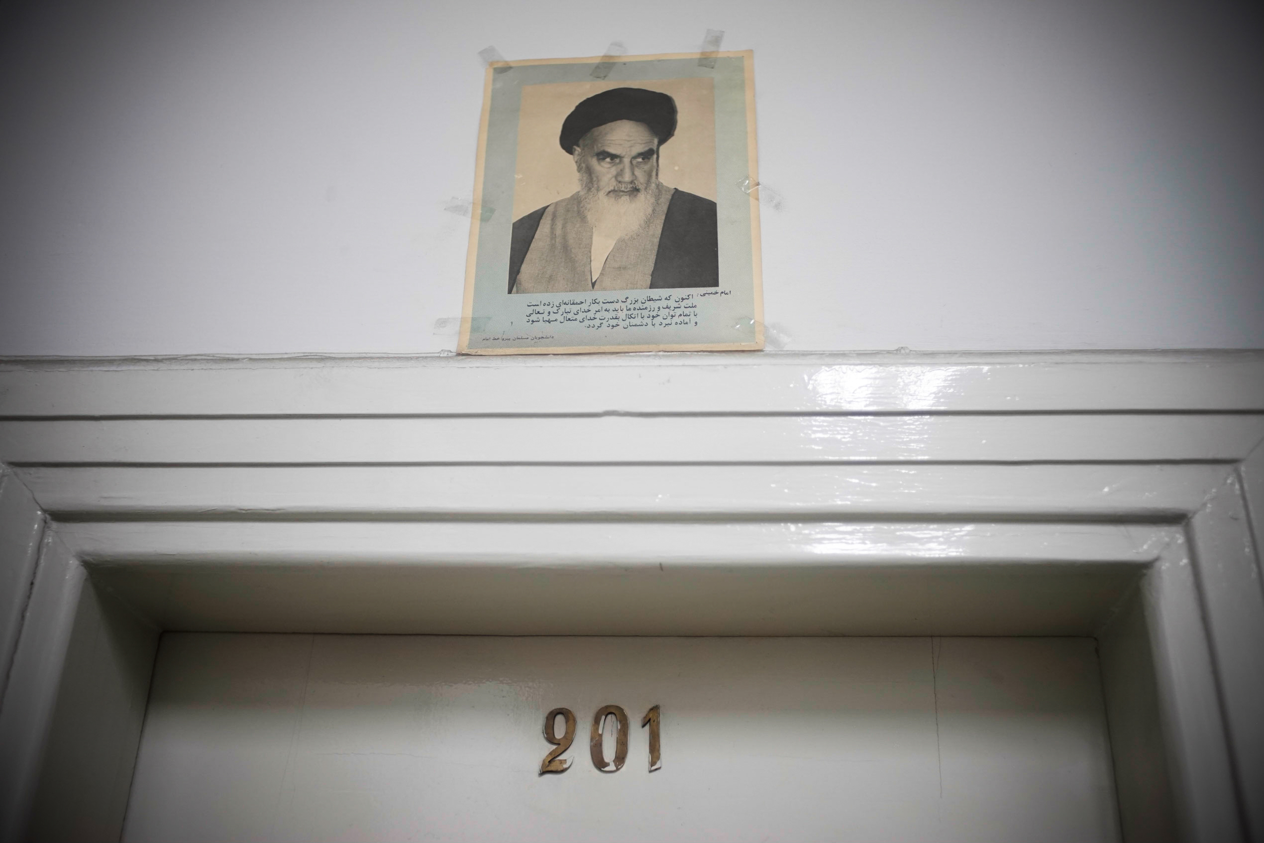 Photo of Ayatollah Khomeini taped above an office door.