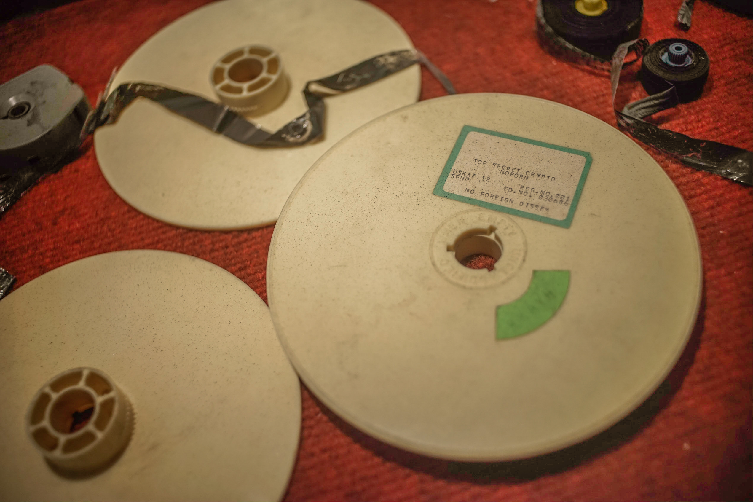 Display case showing reels labeled “Top Secret Crypto.” 