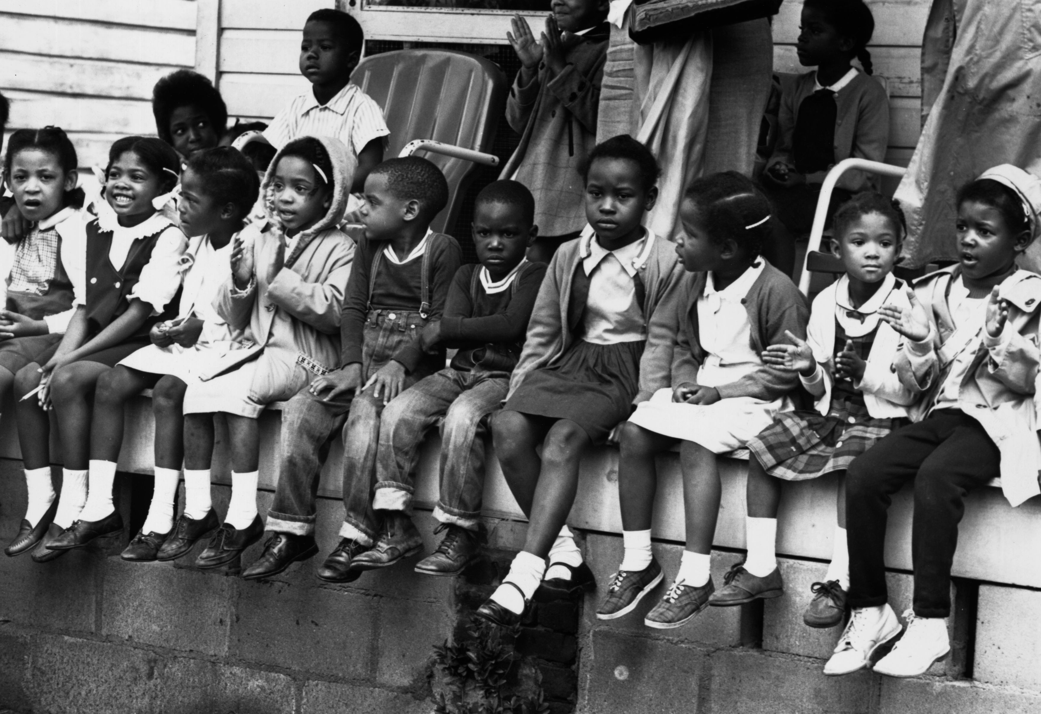 March 1965: Children watching a black voting rights march in Alabama. Dr Martin Luther King led the march from Selma, Alabama, to the state capital in Montgomery. (Photo by William Lovelace/Express/Getty Images)