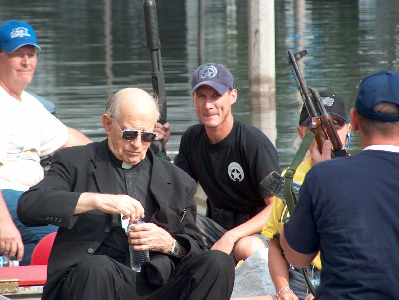 Father Miguel Father Miguel, a Catholic priest who served at Charity for what Bryant-Penland says is "as long as I can remember," being evacuated by a Wildlife and Fisheries airboat. -- Photo by Mooney Bryant-Penland