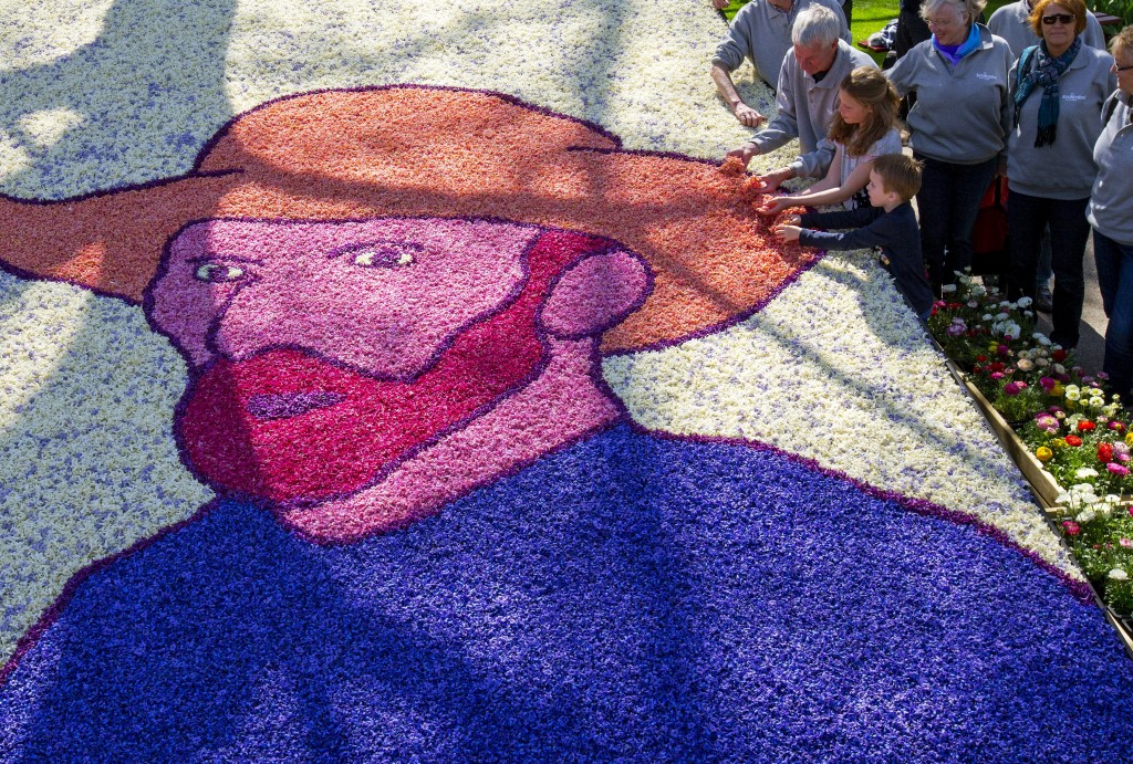 Children place the last petals on a portrait of painter Vincent Van Gogh at the Keukenhof park. Photo: REUTERS/Yves Herman