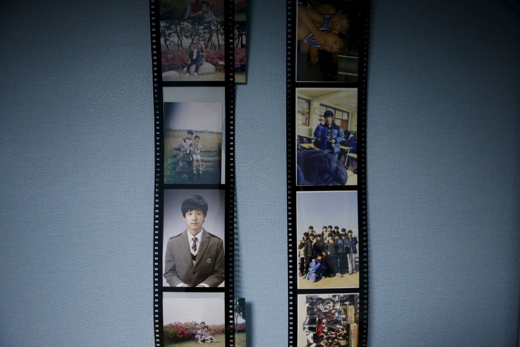 Pictures hang in the bedroom of Jung Hwi-beom, a high school student who died in the Sewol ferry disaster, in Ansan April 7, 2015. His dream was to be a car designer. Photo by Kim Hong-Ji/Reuters