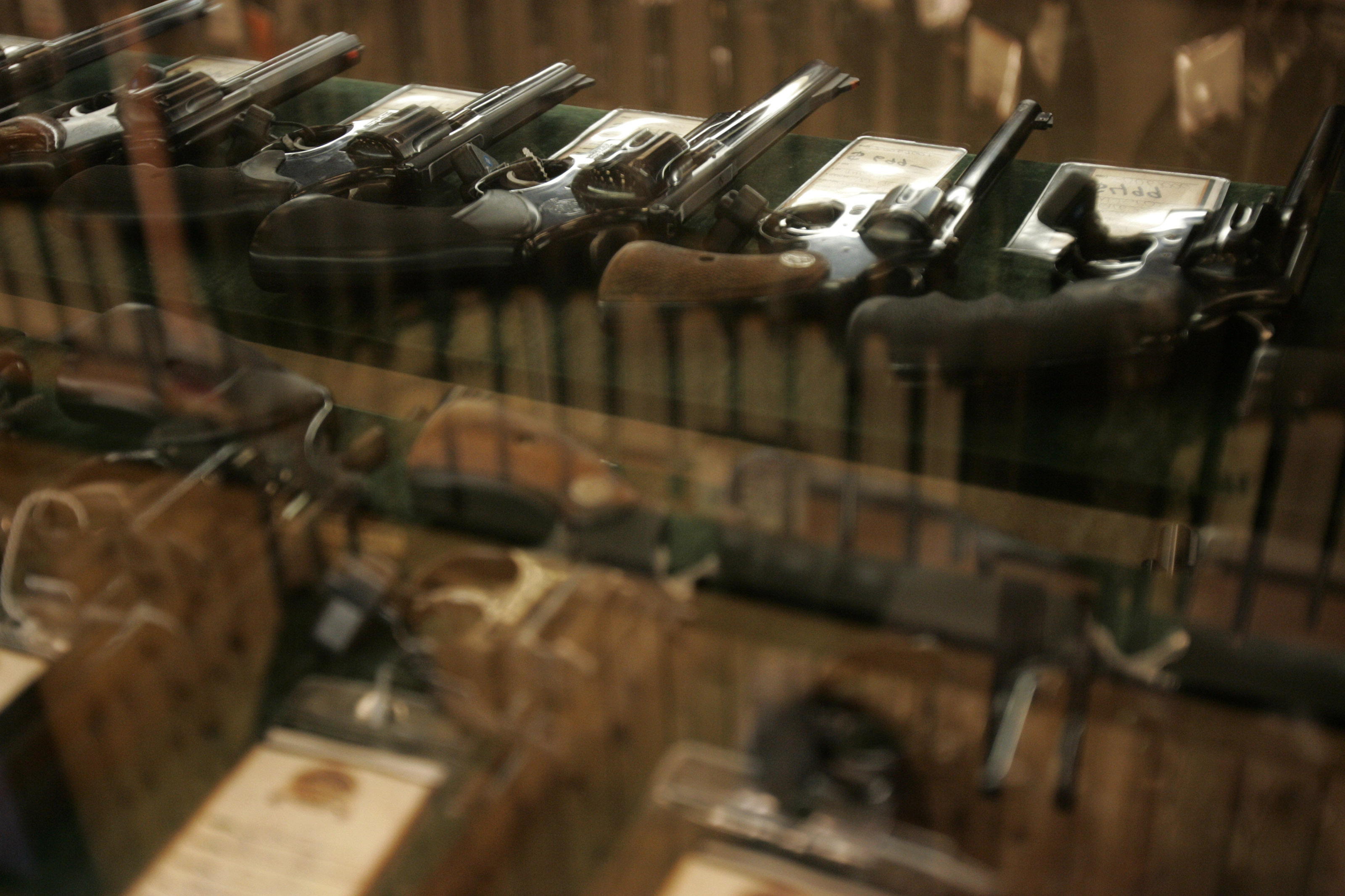 Guns on sale are stored in a case at a gun store in Fort Worth, Texas June 26, 2008. Texas is poised to legalize open carry of handguns for licensed residents. Photo by Jessica Rinaldi/Reuters